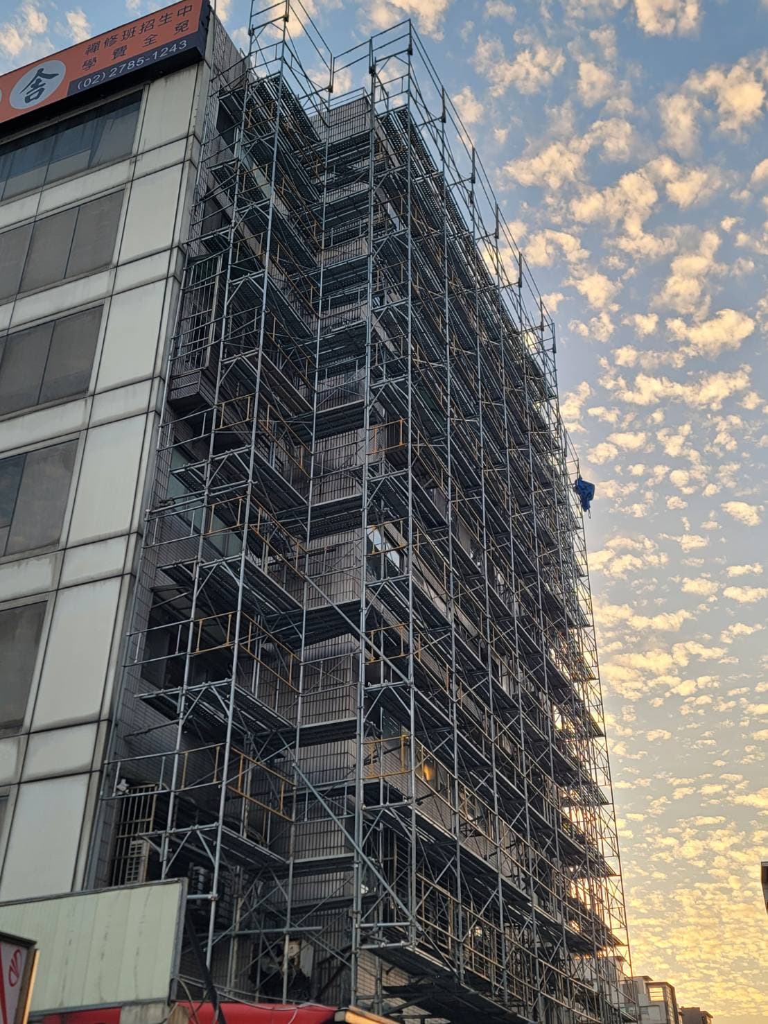 柏凱鷹架工程於台北南港中台講堂大樓架設之多層系統式施工架，展現精密的大樓立面佈建與高空安全防護。