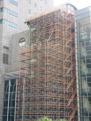 新北市政府行政大樓複雜建築外觀與圓弧結構的外牆維護鷹架搭設照